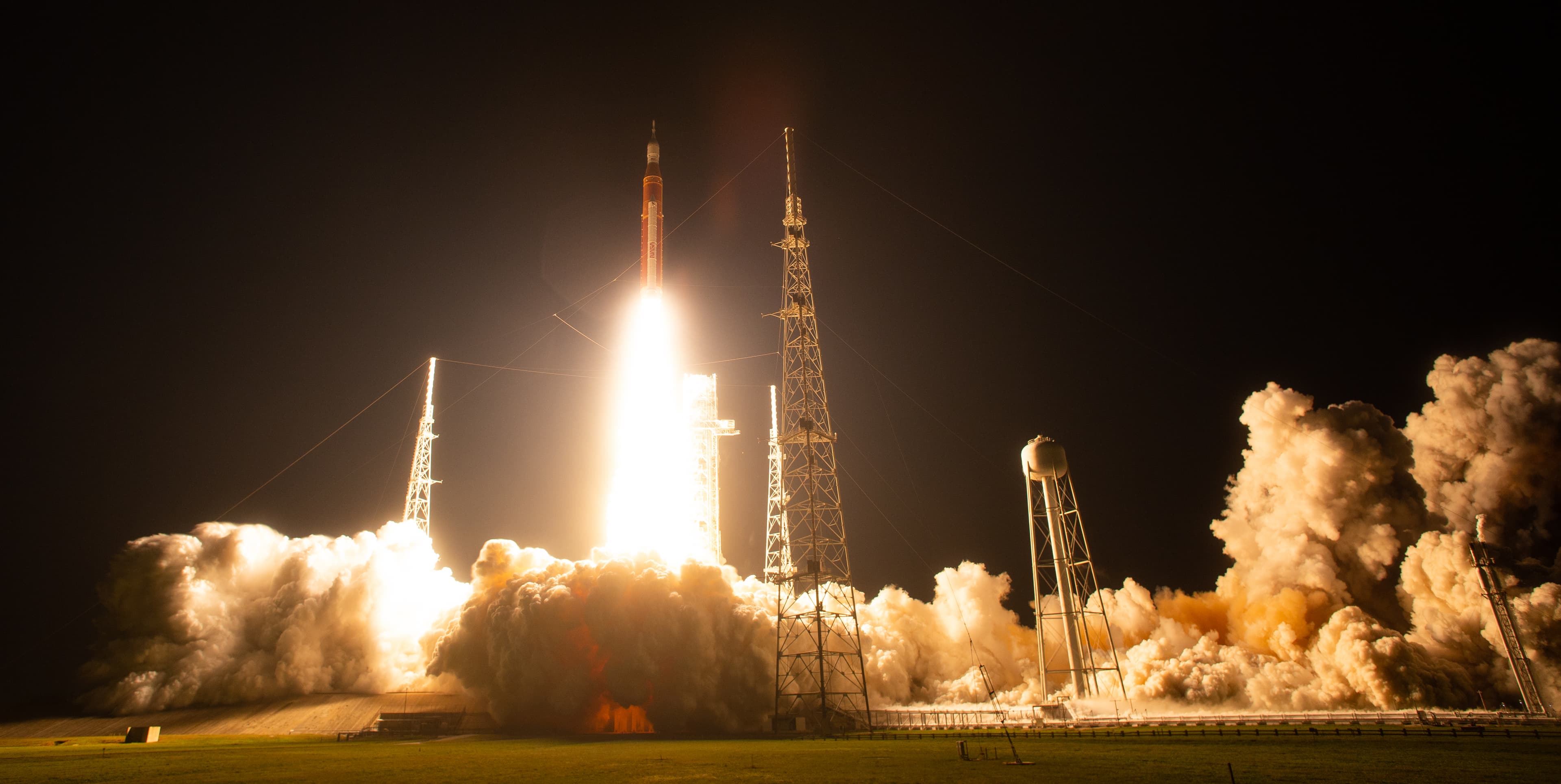 NASA's Artemis I mission lifting off at night on the Space Launch System rocket.